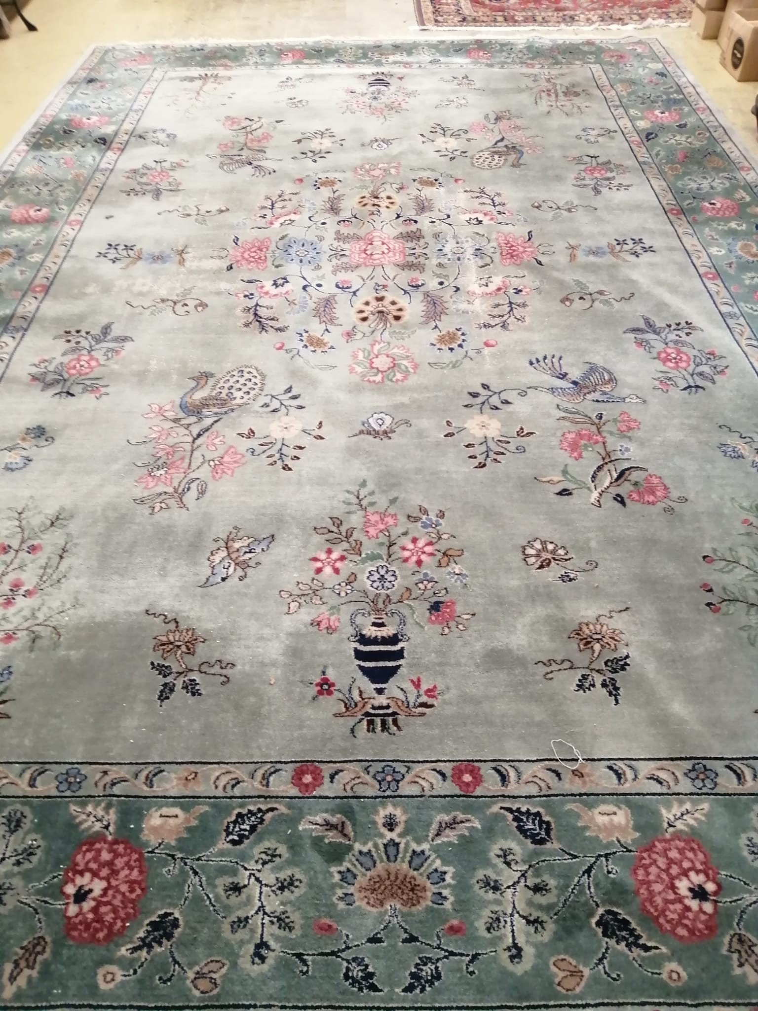 A Chinese Celadon ground floral blue ground carpet, approx. 544 x 366cm